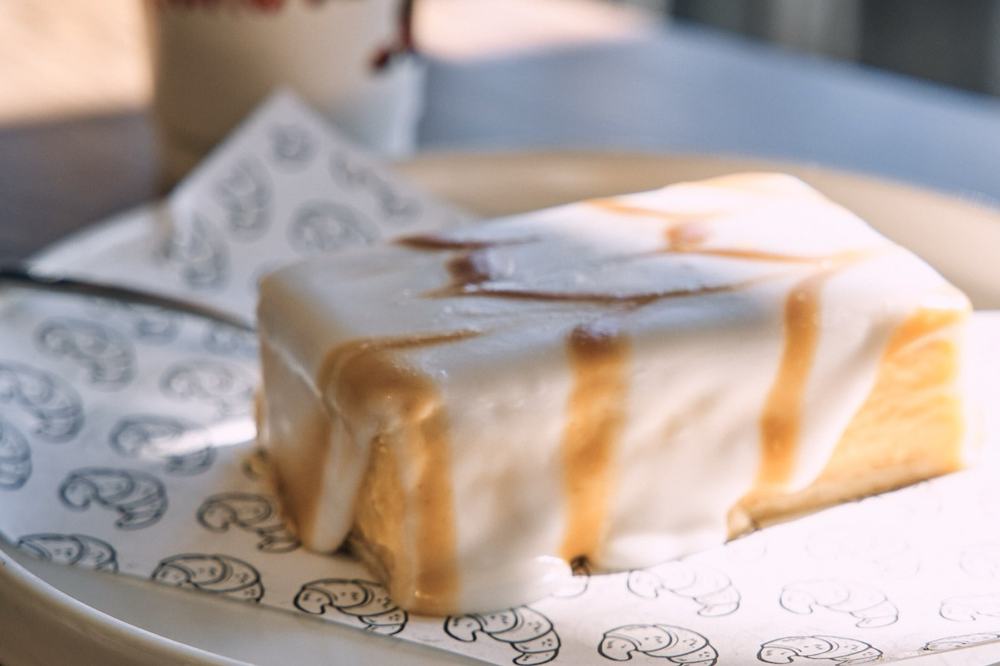 Caramel slice on Jacques Bakery paper with coffee